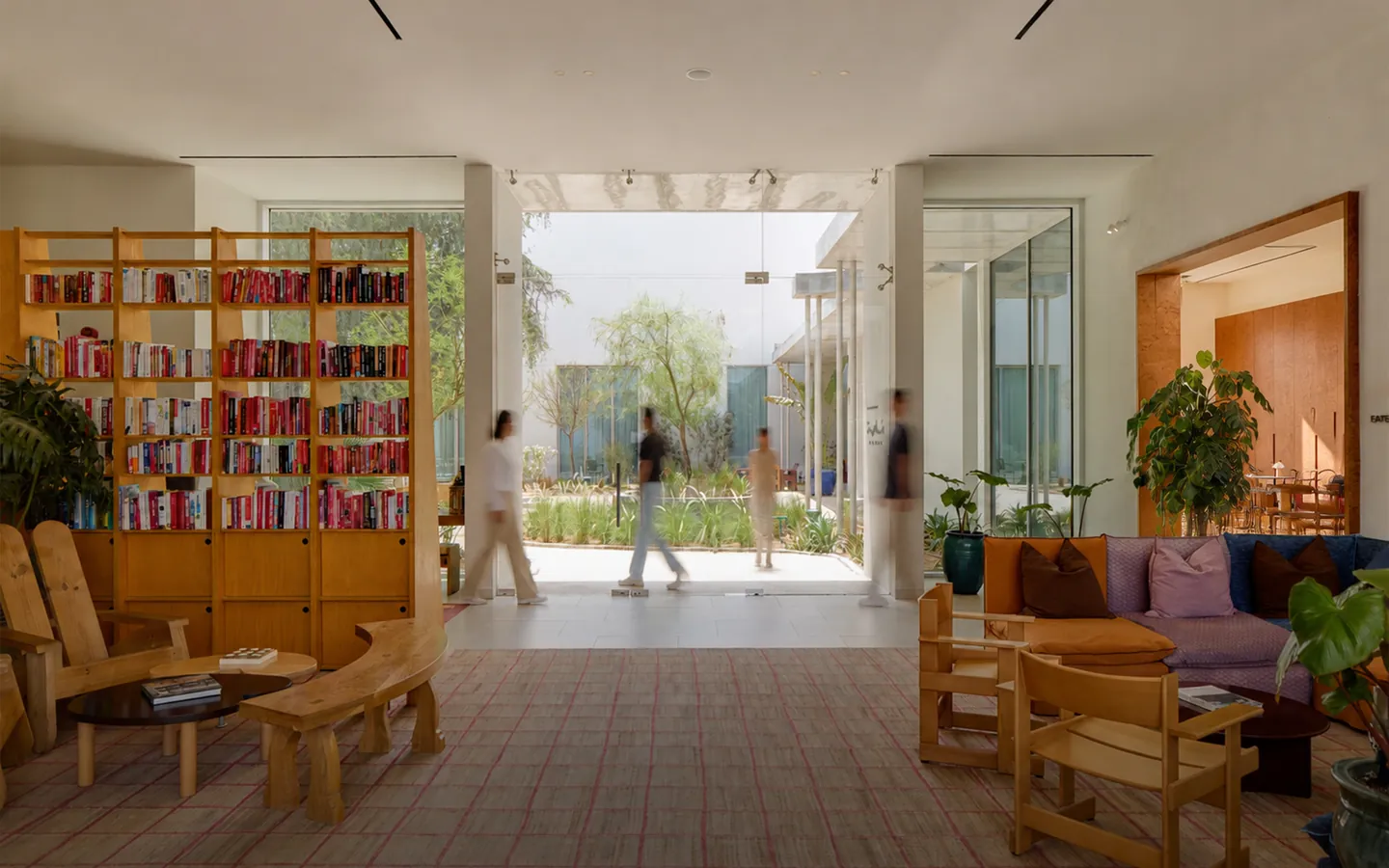 The Paus lounge and library opening onto the courtyard, with members walking through